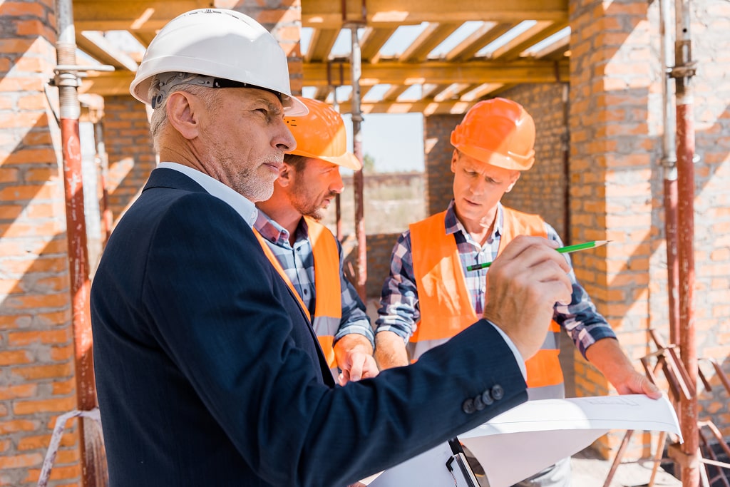 mature businessman in suit near architects in helm 2024 11 08 18 56 44 utc 1 min
